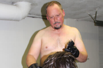 Picture of Master Richard preparing to shave a slave's head